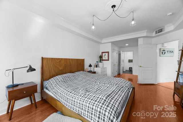 415 N Church St Unit 311, Charlotte, NC 28202 - bedroom featuring crown molding, wood finished floors, and a closet