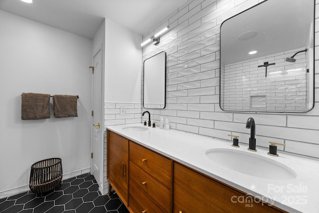 415 N Church St Unit 311, Charlotte, NC 28202 - full bathroom featuring double vanity, decorative backsplash, tile patterned floors, and a tile shower
