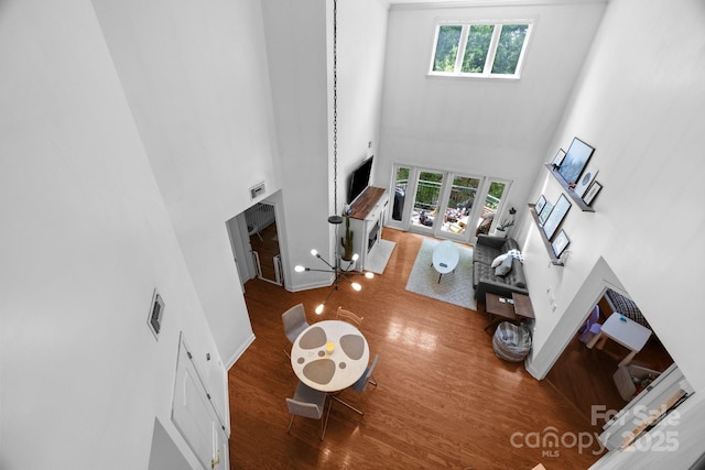 415 N Church St Unit 311, Charlotte, NC 28202 - living area featuring a towering ceiling, wood finished floors, healthy amount of natural light, and a fireplace