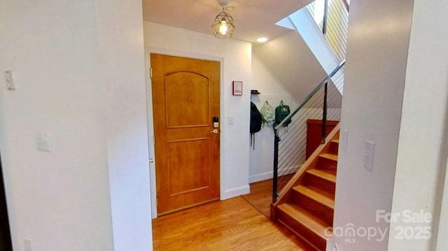 415 N Church St Unit 311, Charlotte, NC 28202 - entrance foyer with stairway, lofted ceiling, light wood-style flooring, and a skylight