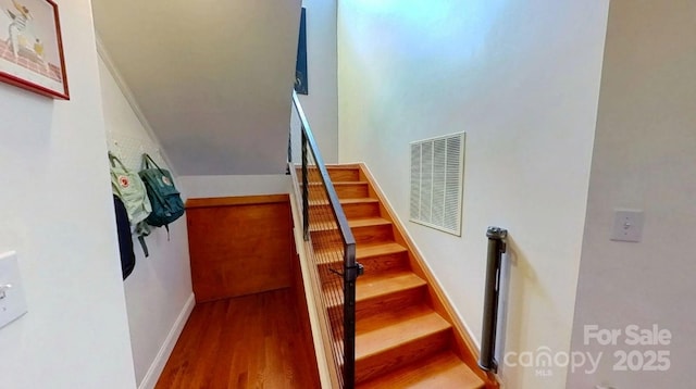 415 N Church St Unit 311, Charlotte, NC 28202 - staircase featuring wood finished floors and vaulted ceiling