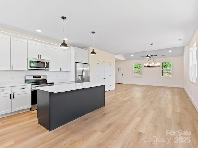 169 Vineyard Village Dr S Unit 4, Old Fort, NC 28762 - kitchen featuring appliances with stainless steel finishes, a chandelier, a kitchen island, white cabinetry, and recessed lighting
