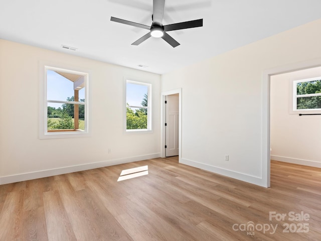169 Vineyard Village Dr S Unit 4, Old Fort, NC 28762 - unfurnished bedroom with light wood-type flooring, a ceiling fan, and a walk in closet