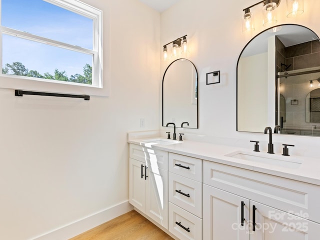 169 Vineyard Village Dr S Unit 4, Old Fort, NC 28762 - bathroom with double vanity, a stall shower, and wood finished floors