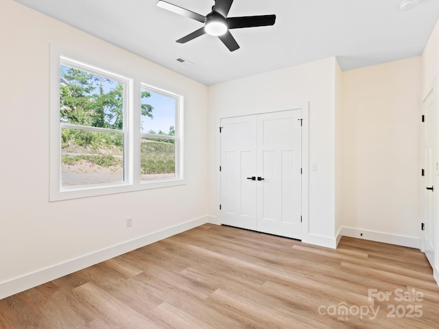 169 Vineyard Village Dr S Unit 4, Old Fort, NC 28762 - unfurnished bedroom featuring light wood finished floors, a ceiling fan, and a closet