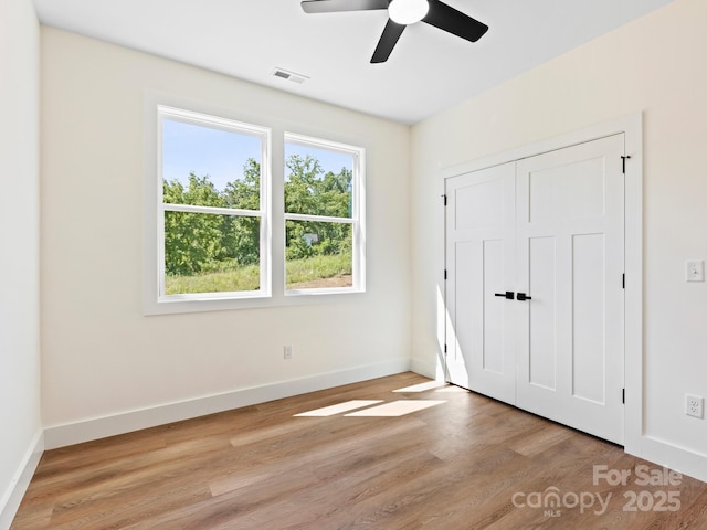 169 Vineyard Village Dr S Unit 4, Old Fort, NC 28762 - unfurnished bedroom with light wood-style floors, a ceiling fan, and a closet