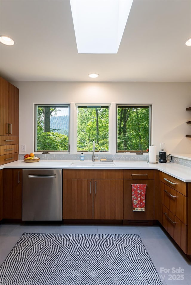 12 Beech Tree Ln, Asheville, NC 28804 - kitchen with stainless steel dishwasher, plenty of natural light, light countertops, a skylight, and recessed lighting
