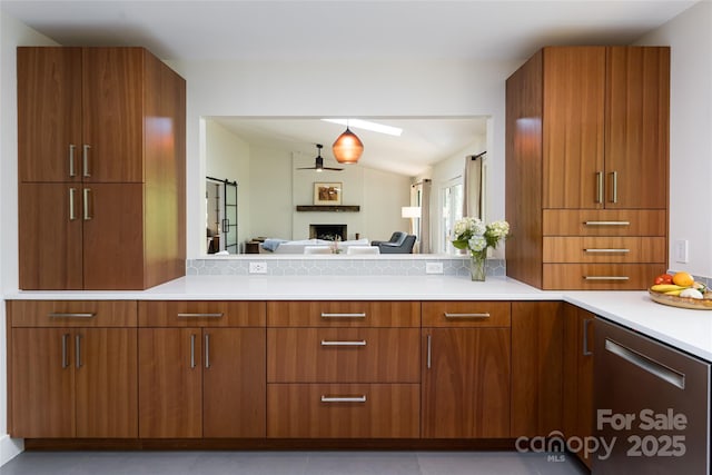 12 Beech Tree Ln, Asheville, NC 28804 - kitchen with a fireplace, brown cabinets, ceiling fan, and modern cabinets