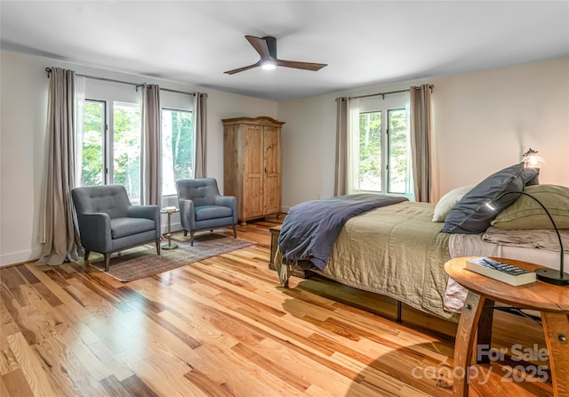 12 Beech Tree Ln, Asheville, NC 28804 - bedroom featuring multiple windows, light wood-style flooring, and a ceiling fan