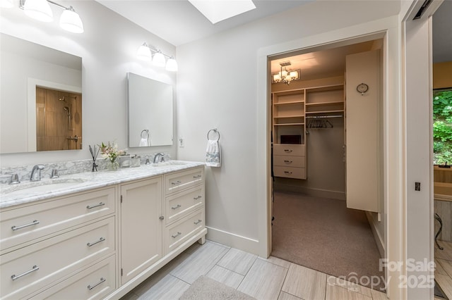12 Beech Tree Ln, Asheville, NC 28804 - bathroom featuring a skylight, double vanity, and a walk in closet