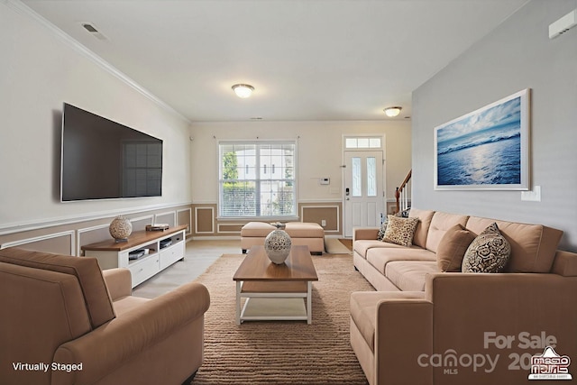 8915 Merrie Rose Ave, Charlotte, NC 28213 - living area with wainscoting, ornamental molding, a decorative wall, and stairway