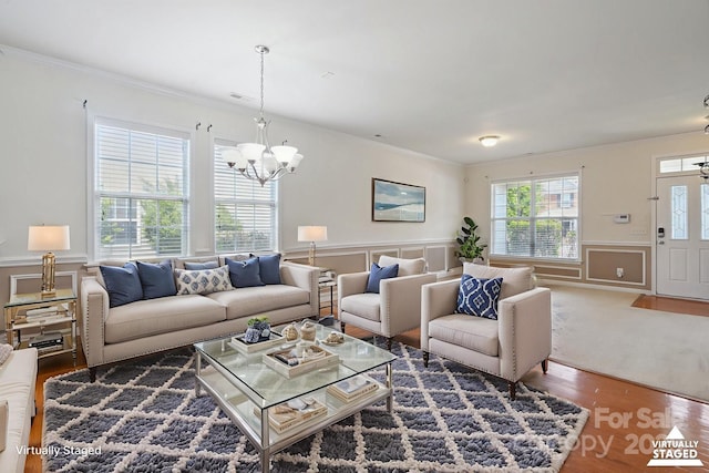 8915 Merrie Rose Ave, Charlotte, NC 28213 - living area with a chandelier, ornamental molding, wainscoting, and wood finished floors