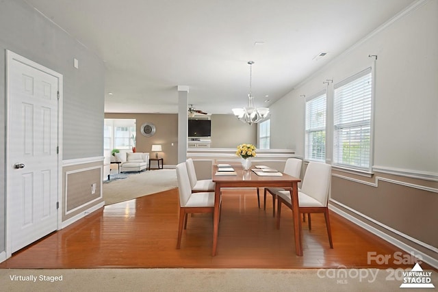 8915 Merrie Rose Ave, Charlotte, NC 28213 - dining space with wood finished floors, a chandelier, and ornamental molding