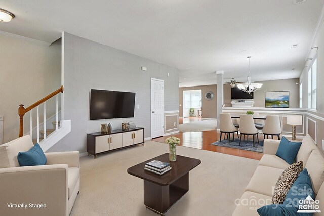 8915 Merrie Rose Ave, Charlotte, NC 28213 - carpeted living room with a chandelier and stairway
