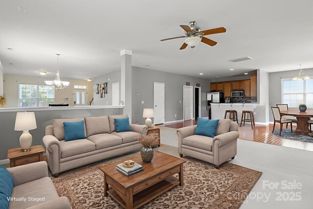 8915 Merrie Rose Ave, Charlotte, NC 28213 - living room with a chandelier, ceiling fan, and recessed lighting