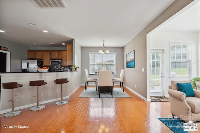8915 Merrie Rose Ave, Charlotte, NC 28213 - dining room featuring light wood-type flooring, a chandelier, and recessed lighting