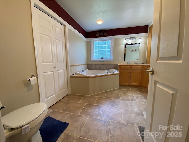 5570 George Henry Dr, Hickory, NC 28602 - bathroom featuring vanity, stone tile flooring, a bath, and a closet