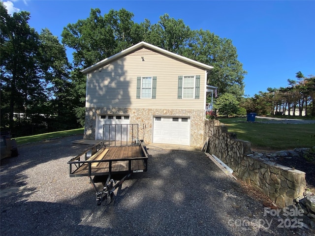 5570 George Henry Dr, Hickory, NC 28602 - view of property exterior with asphalt driveway, a garage, and stone siding