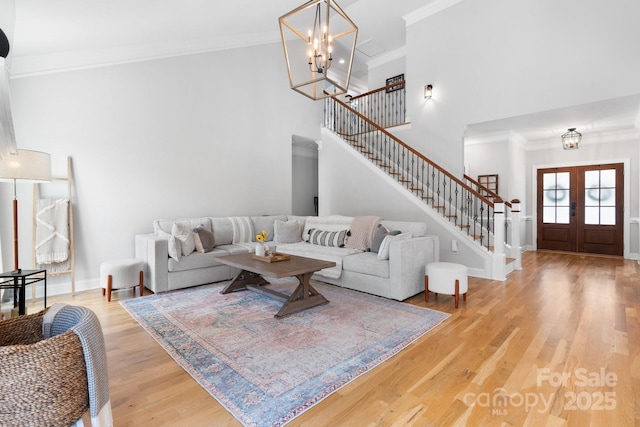 3622 46th Ave NE, Hickory, NC 28601 - living room with stairs, crown molding, light wood-style floors, a high ceiling, and french doors