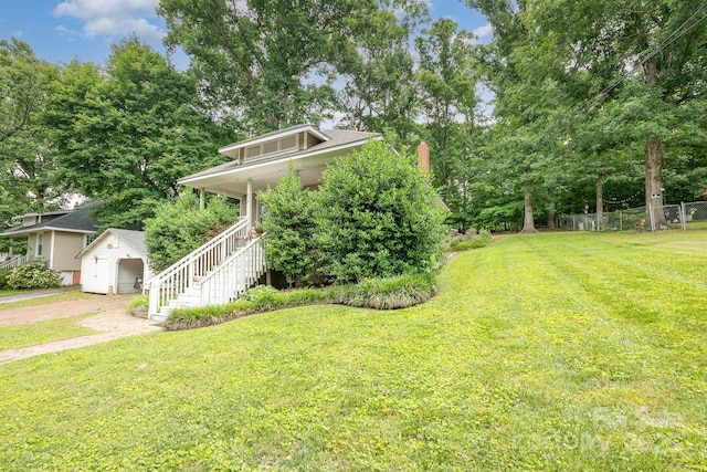 816 Fulton St, Albemarle, NC 28001 - view of yard with driveway, stairs, a garage, an outbuilding, and a porch