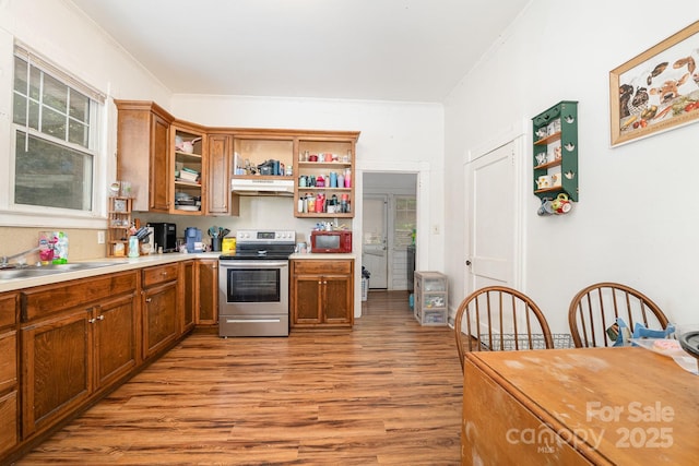 816 Fulton St, Albemarle, NC 28001 - kitchen with stainless steel range with electric cooktop, open shelves, under cabinet range hood, a sink, and light wood-style floors