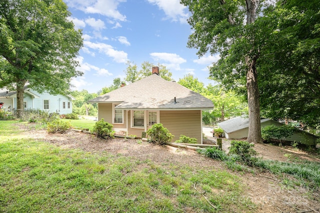 816 Fulton St, Albemarle, NC 28001 - back of house featuring a chimney and a lawn