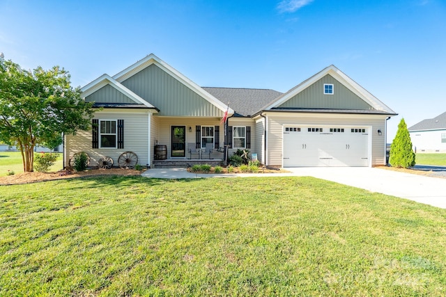 17438 Purser Dr, Locust, NC 28097 - view of front of property with covered porch, an attached garage, driveway, a front lawn, and board and batten siding