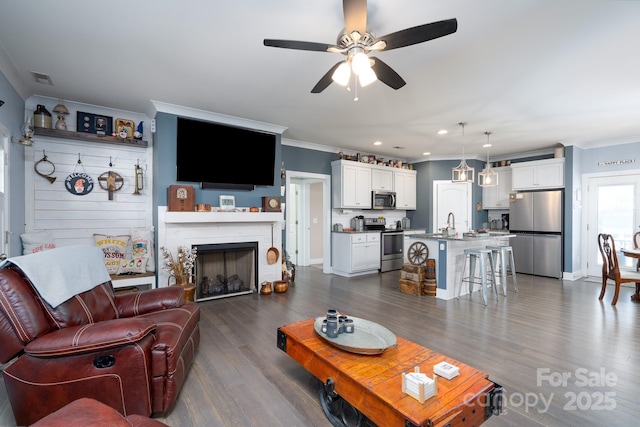 17438 Purser Dr, Locust, NC 28097 - living room featuring crown molding, ceiling fan, dark wood-style flooring, a fireplace, and recessed lighting