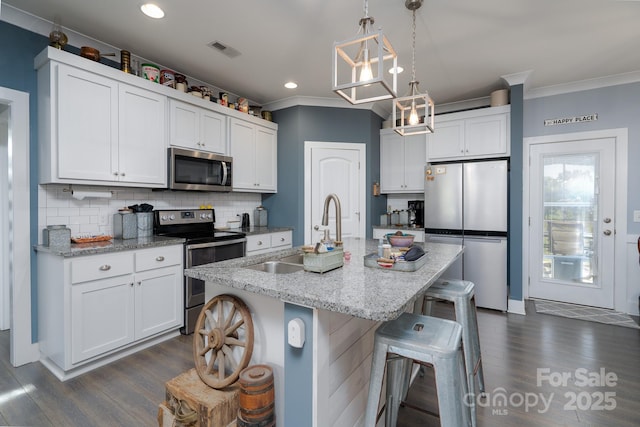 17438 Purser Dr, Locust, NC 28097 - kitchen featuring stainless steel appliances, crown molding, dark wood-style floors, a breakfast bar, and backsplash