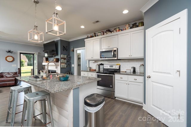 17438 Purser Dr, Locust, NC 28097 - kitchen with stainless steel appliances, dark wood finished floors, light stone countertops, decorative backsplash, and ornamental molding