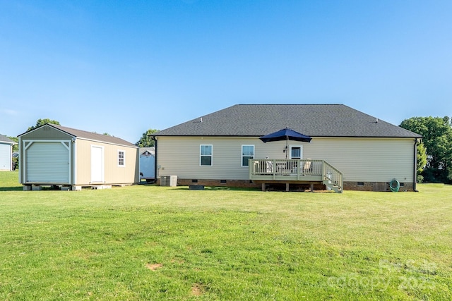 17438 Purser Dr, Locust, NC 28097 - back of property featuring crawl space, a deck, a lawn, a storage shed, and a shingled roof