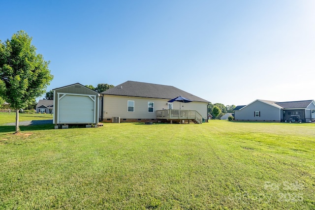 17438 Purser Dr, Locust, NC 28097 - rear view of house with a deck, a lawn, crawl space, and a storage unit