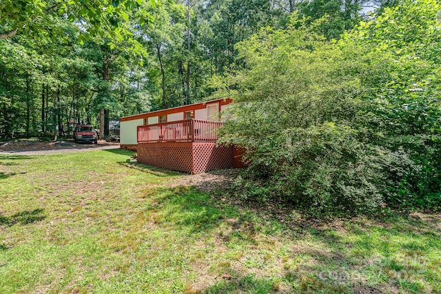 5239 Lineberger Rd, Stanley, NC 28164 - view of green lawn with a deck and a view of trees