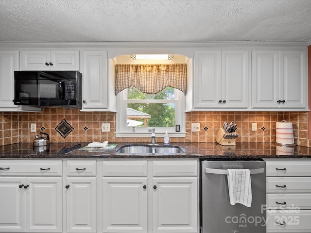 3509 Flint Dr, Statesville, NC 28677 - kitchen with stainless steel dishwasher, black microwave, white cabinetry, dark stone countertops, and decorative backsplash