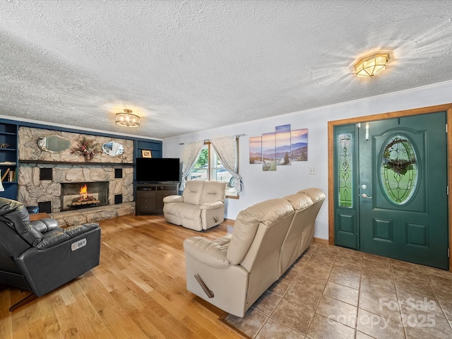 3509 Flint Dr, Statesville, NC 28677 - living area with a stone fireplace, a textured ceiling, and wood finished floors