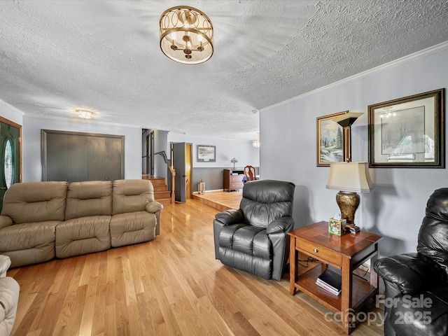 3509 Flint Dr, Statesville, NC 28677 - living area with a textured ceiling, light wood-type flooring, crown molding, stairs, and a chandelier