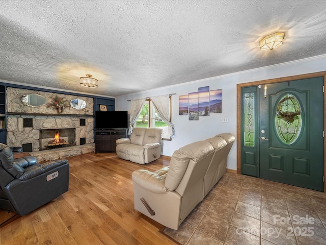 3509 Flint Dr, Statesville, NC 28677 - living area featuring a stone fireplace, ornamental molding, wood finished floors, and a textured ceiling