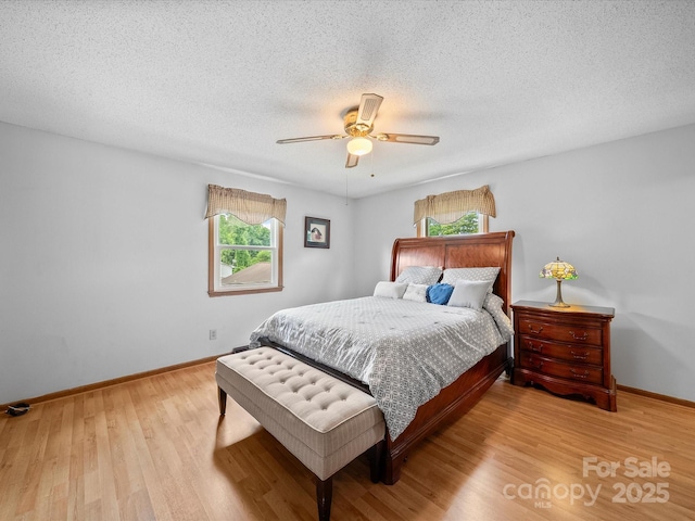 3509 Flint Dr, Statesville, NC 28677 - bedroom featuring wood finished floors, a textured ceiling, and a ceiling fan