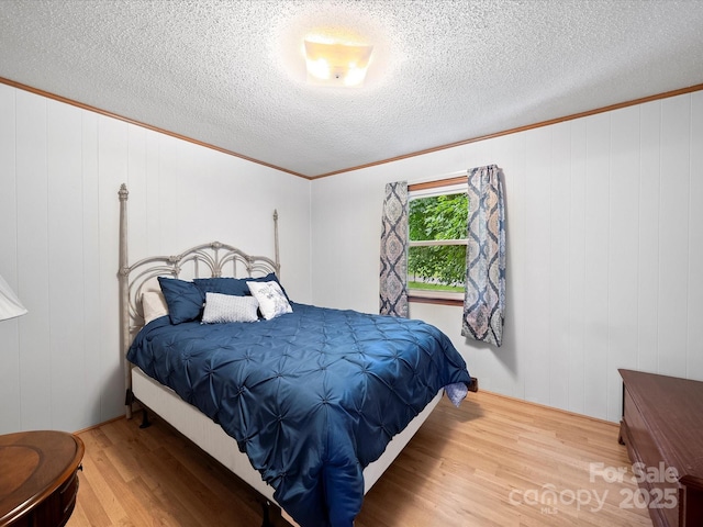 3509 Flint Dr, Statesville, NC 28677 - bedroom with wood finished floors, a textured ceiling, and ornamental molding
