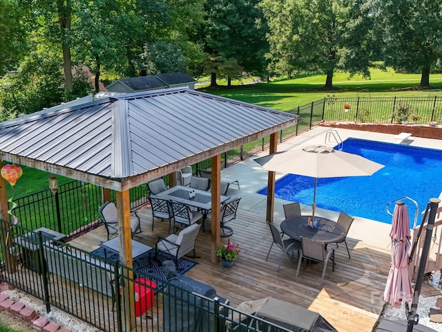 3509 Flint Dr, Statesville, NC 28677 - view of swimming pool with a gazebo, outdoor dining area, a wooden deck, and view of wooded area