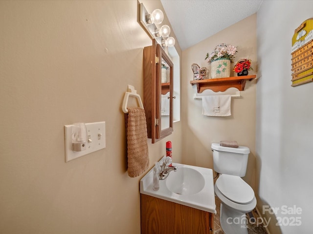 3509 Flint Dr, Statesville, NC 28677 - half bathroom featuring vanity and a textured ceiling