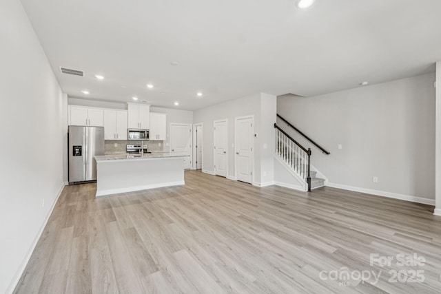 108 Ciara Pl Unit E, Mooresville, NC 28117 - unfurnished living room with recessed lighting, stairs, and light wood-style flooring