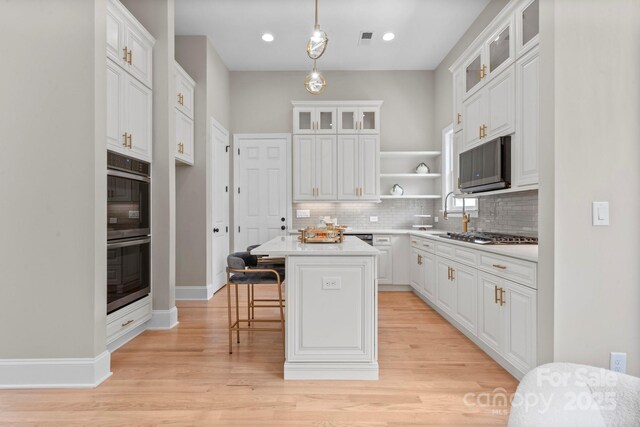 4015 Randolph Rd, Charlotte, NC 28211 - kitchen with appliances with stainless steel finishes, open shelves, decorative backsplash, a kitchen island, and recessed lighting