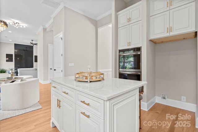 4015 Randolph Rd, Charlotte, NC 28211 - kitchen featuring light wood-type flooring, a ceiling fan, double oven, ornamental molding, and light stone countertops