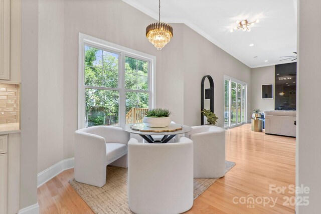 4015 Randolph Rd, Charlotte, NC 28211 - dining space featuring light wood-style flooring, crown molding, and a chandelier