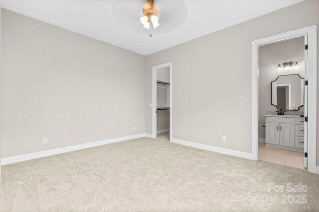 4015 Randolph Rd, Charlotte, NC 28211 - unfurnished bedroom featuring light colored carpet, a spacious closet, connected bathroom, a closet, and ceiling fan