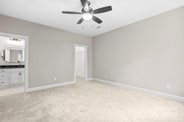 4015 Randolph Rd, Charlotte, NC 28211 - unfurnished bedroom with light colored carpet, a spacious closet, connected bathroom, a ceiling fan, and a closet
