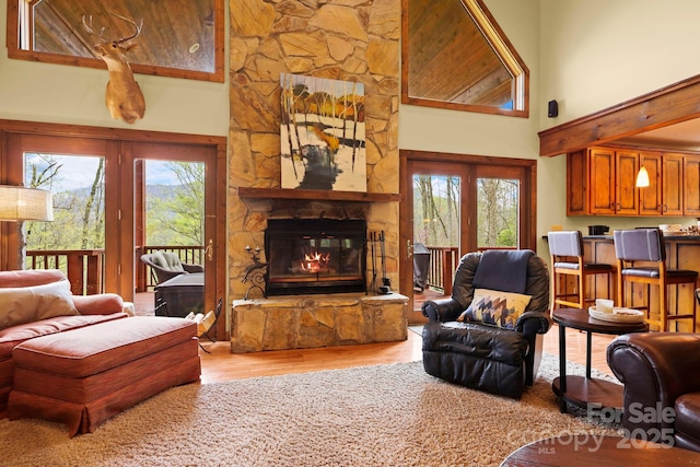 40 Ollis Ridge Ln, Elk Park, NC 28622 - living area featuring light wood-style floors, a stone fireplace, and a towering ceiling