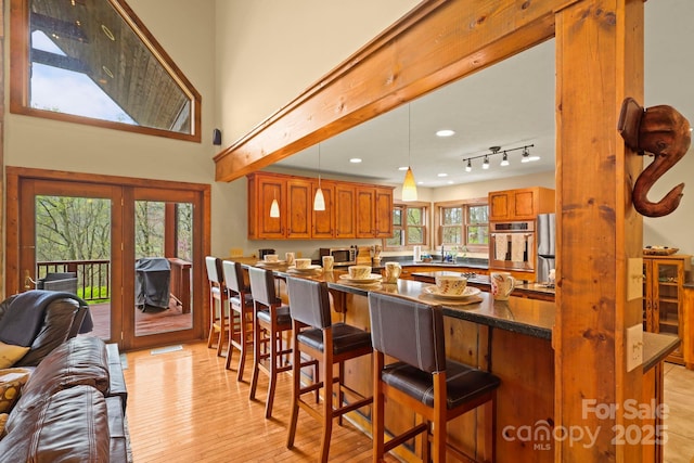 40 Ollis Ridge Ln, Elk Park, NC 28622 - kitchen with plenty of natural light, open floor plan, light wood-type flooring, brown cabinetry, and recessed lighting