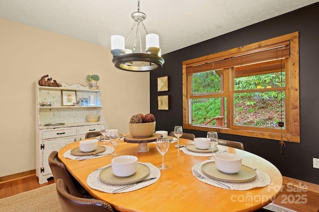 40 Ollis Ridge Ln, Elk Park, NC 28622 - dining room featuring a chandelier, wood finished floors, and baseboards